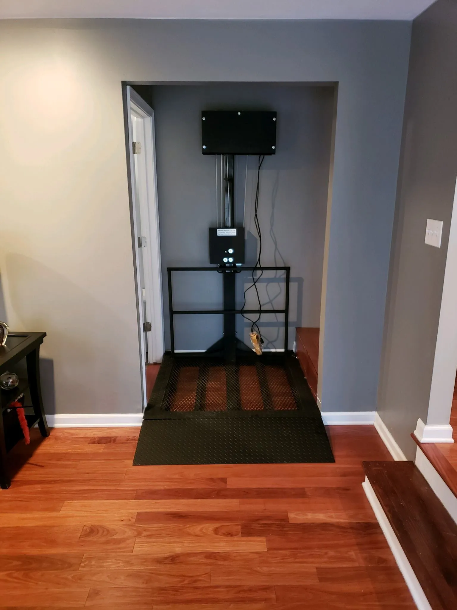 Compact outdoor lift beside a porch landing
